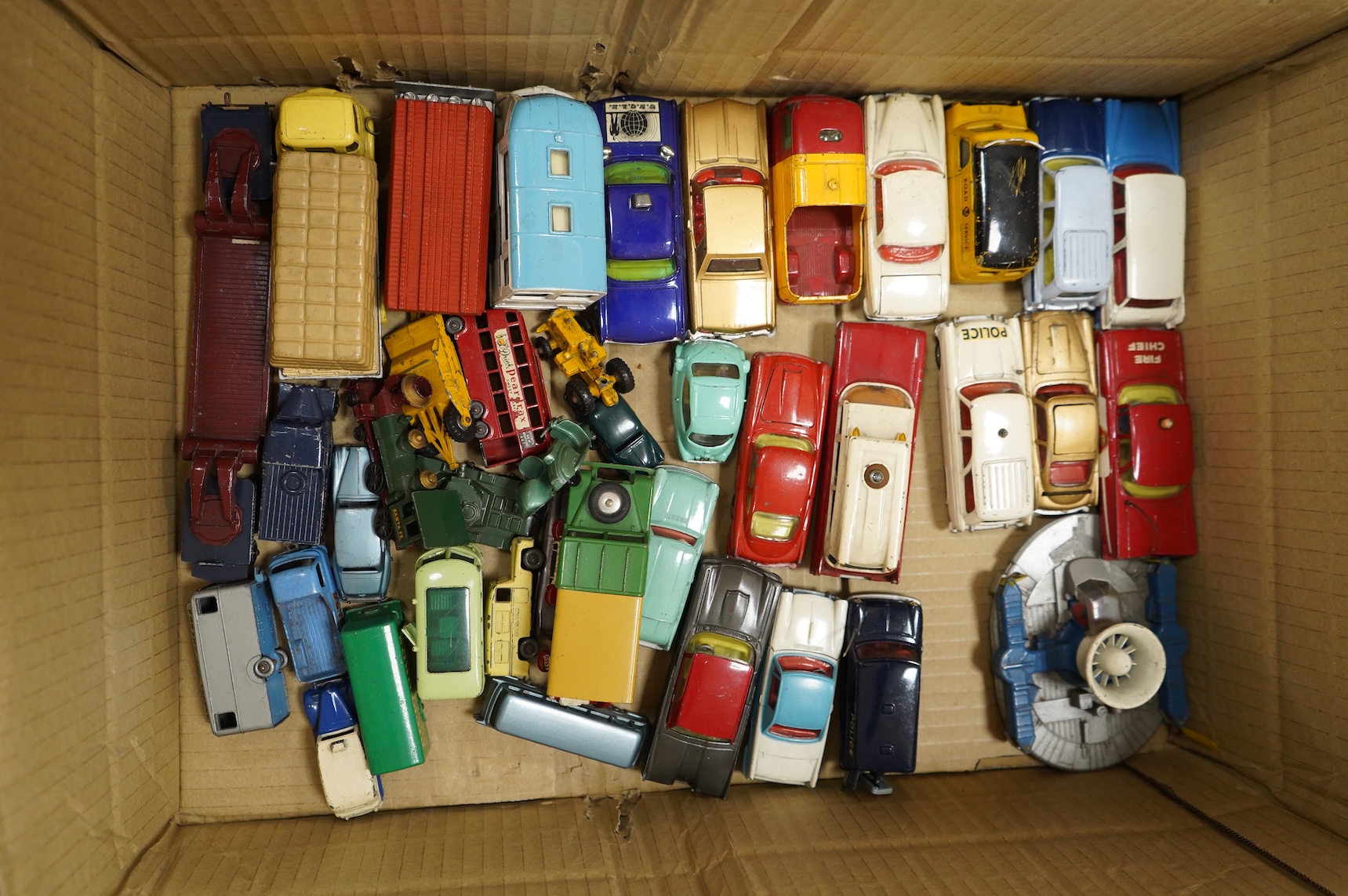 A collection of forty Corgi Toys and fourteen Matchbox Series diecast vehicles, including; The Man From Uncle Oldsmobile, a James Bond Aston Martin DB5 in gold, a Commer 5-ton truck with trailer and a selection of loads,